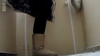 White chick in uggs and coat pisses in the public toilet