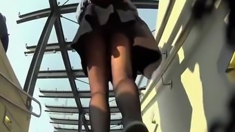 Woman in short black skirt and pantyhose upskirted