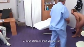 Pregnant woman has fun with her doctor in the hospital