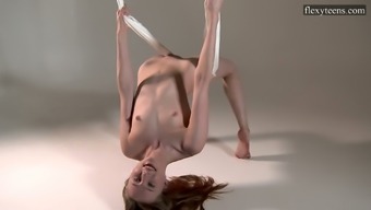 Flexible Russian gymnast Sofia Zhiraf gets naked in the aerial hammock