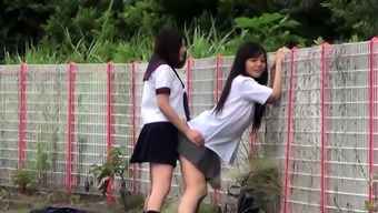 Asian teenagers outdoors urinate