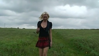 Wondrous big breasted blonde MILF flashes butt while pissing in the field