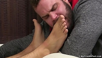 Erotic home video of a guy with glasses licking feet of his friend