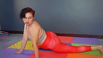 Regina Noir. A woman in yoga leotards practices yoga in the gym. Transparent red leotard yoga.