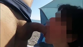 French milf gives an amateur blowjob on a public nude beach to a stranger