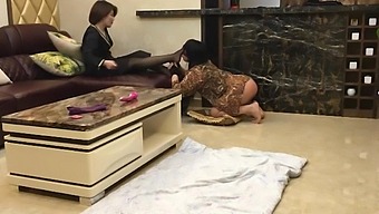 Asian milf in stockings humiliates crossdresser with sex toy