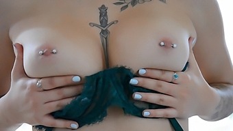 Busty brunette Bella with pierced nipples sensually undresses